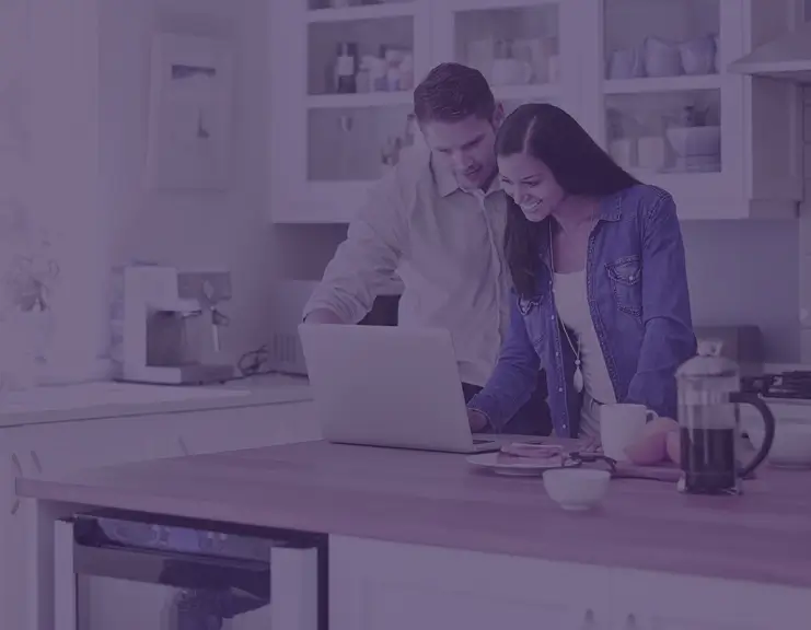 A father and daughter sitting on a kitchen island