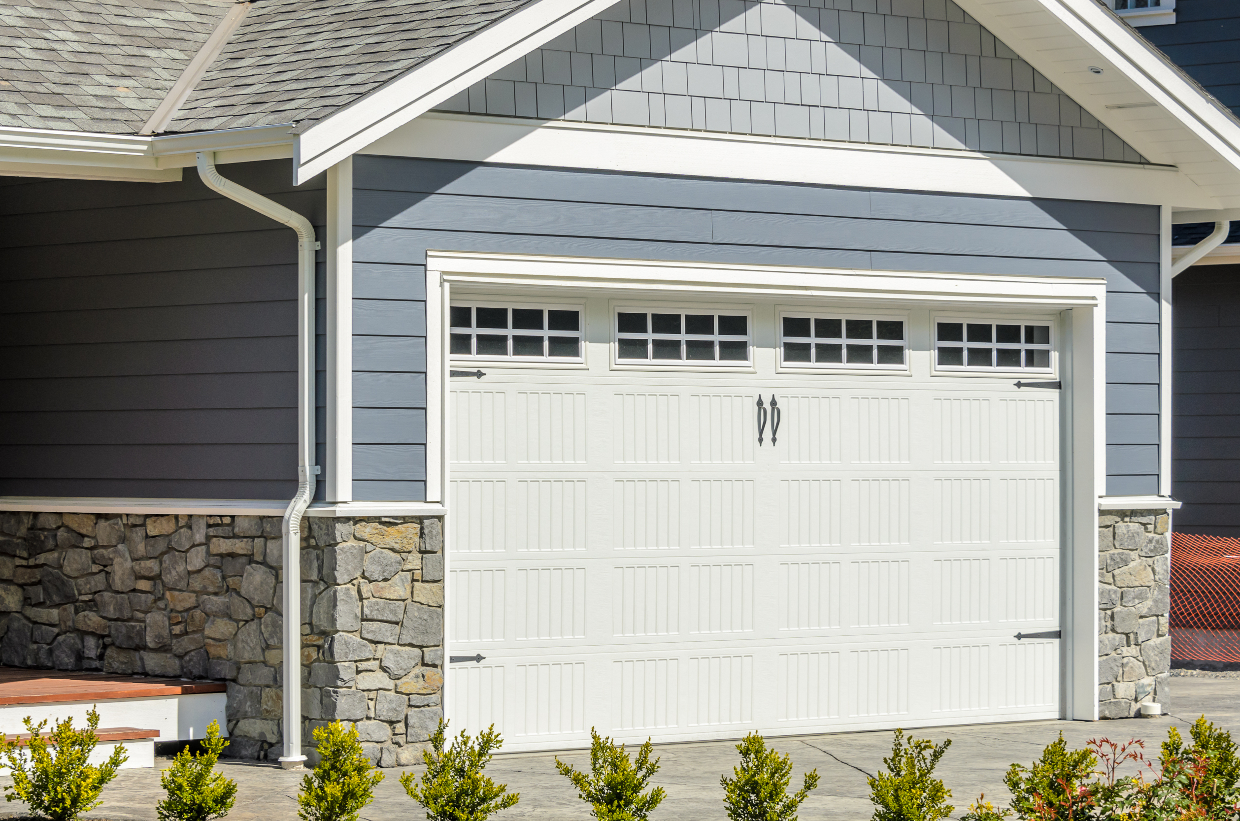 Shot of a gray house white garage door