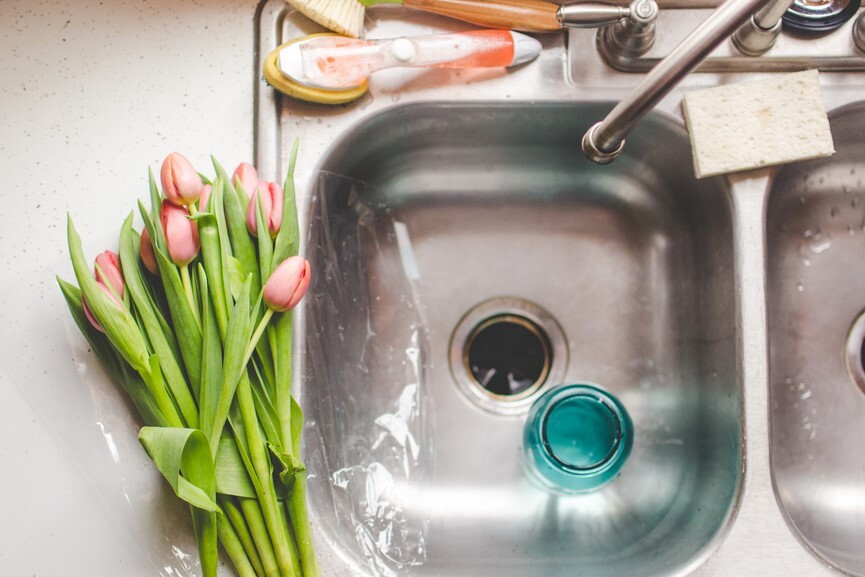 A sink with its garbage disposal exposed